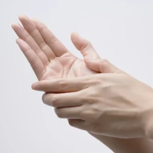 Hands practicing abhyanga self-massage with warm oil for calming vata and menopause support.