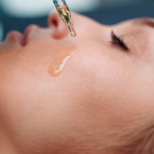 Applying oil as part of a skincare routine.