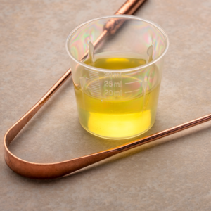 oil pulling with coconut oil and a tongue scraper for detoxification and oral health.