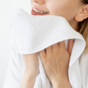 Gently drying the face after Ayurvedic face washing.