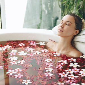 Ayurvedic bath with rose petals and candles for relaxation