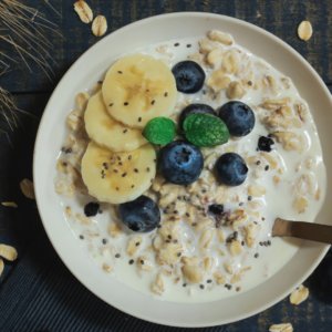Oatmeal bowl topped with fresh blueberries and banana slices.