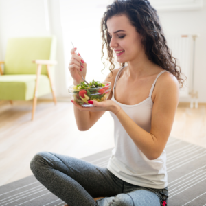 Woman practicing mindful eating with a healthy salad – Ayurvedic Eating