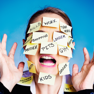A person with sticky notes covering her face labeled 'stressors' like work, kids, and bills, showing emotional overwhelm and burnout linked to Pitta dosha.