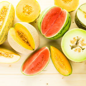 A colorful assortment of melons, including watermelon and cantaloupe, representing cooling foods to pacify Pitta dosha.