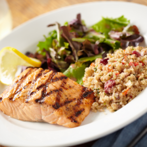 Ayurvedic principles recommend combining protein with vegetables, like salmon with greens, for optimal digestion and overall health.