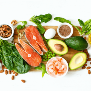 Healthy meal with salmon, avocado, and leafy greens rich in omega-3 and fiber.