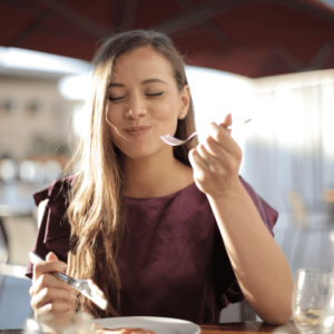 Woman enjoying chewing healthy food for improved digestion and Agni balance