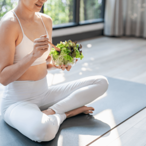 Healthy salad and yoga mat for mindful eating and balancing Agni