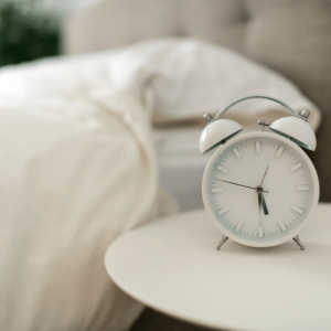 An alarm clock on a bedside table - quality sleep is essential for reducing inflammation naturally.