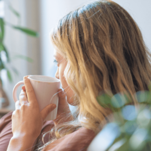 A woman enjoying herbal tea to support relaxation and inflammation relief
