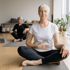A senior woman meditating for stress relief and inflammation reduction through mindfulness.