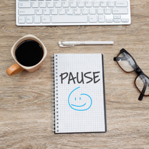 A journal with "Pause" written on it, reminding us to check in on Daily Intentions for better focus.