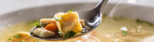 spoon of warm soup supporting digestion in Ayurveda