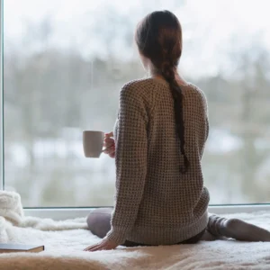 Woman practicing morning tea ritual to restore circadian rhythm during menopause.