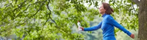 Midlife woman walking outdoors to reduce stress and mental inflammation.