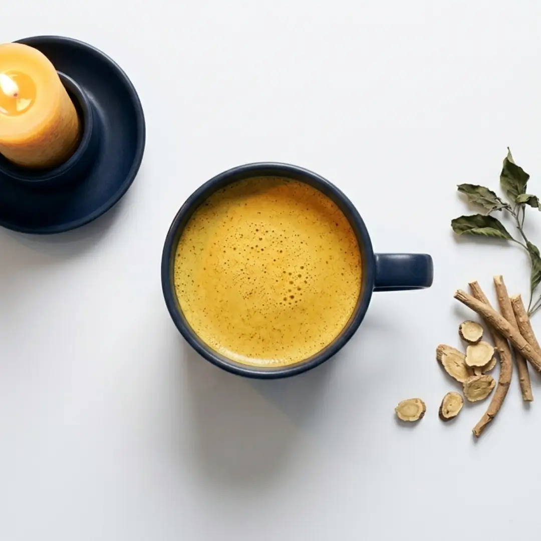 Golden milk with Ayurvedic herbs and candlelight representing calming nighttime rituals for restorative sleep and inflammation recovery.